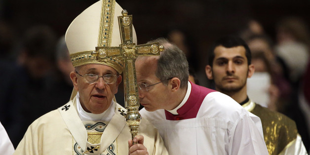 Monsignor Guido Marini, center, shares a word with Pope Francis, left, at the end of an Armenian-Rite Mass to commemorate the 100th anniversary of the Armenian Genocide, in St. Peter's Basilica, at the Vatican, Sunday, April 12, 2015. Pope Francis sparked a diplomatic incident with Turkey on Sunday by calling the slaughter of Armenians by Ottoman Turks âthe first genocide of the 20th century" and urging the international community to recognize it as such. Turkey, which denies a genocide took place, immediately summoned the Vatican ambassador to express its displeasure, a Foreign Ministry spokesman said in Ankara, speaking on customary condition of anonymity. (AP Photo/Gregorio Borgia)