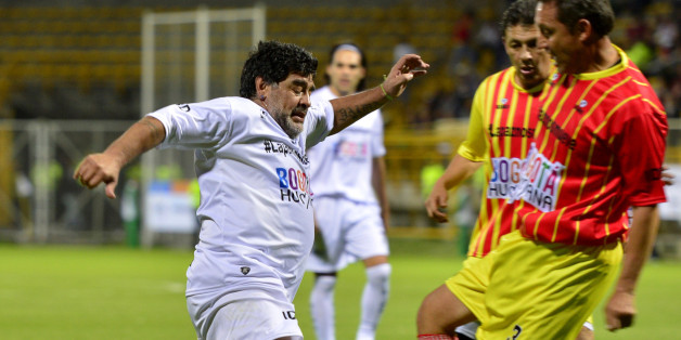 Argentina's soccer legend Diego Armando Maradona, left, controls the ball during an exhibition soccer match in support of peace talks between the Colombian government and leftist rebels in Bogota, Colombia, Friday, April 10, 2015. Delegates of the government and rebels of the Revolutionary Armed Forces of Colombia, FARC, are negotiating in Havana. (AP Photo/Santiago Cortes)