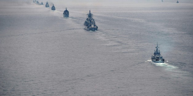 FILE - In this Tuesday, July 16, 2013 file photo Russian Pacific Navy ships sail near the Sakhalin Island during military exercises. With hundreds of new aircraft, tanks and missiles rolling off assembly lines and Russian jets buzzing European skies under NATOâs wary eye, it doesnât look like Russiaâs economic woes have had any impact on the Kremlinâs ambitious military modernization program. (AP Photo/RIA Novosti, Alexei Nikolsky, Presidential Press Service, File)
