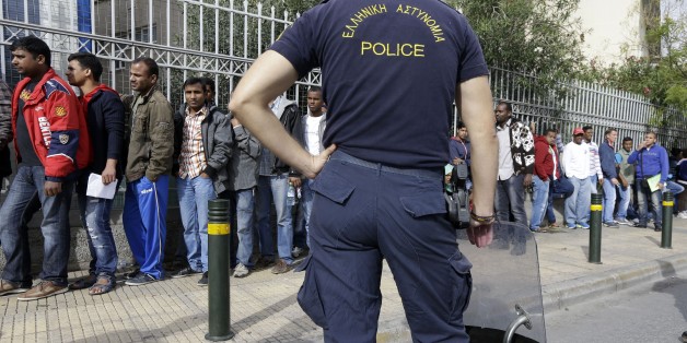 Immigrants from various countries queue outside Greece's Central Asylum Service in Athens on Wednesday, Oct. 8, 2014. The United Nations refugee agency is calling on the European Union to overhaul its policy toward Syrian refugees, warning the number of fatal accidents at sea could rise further as winter approaches. Greek authorities says they expect a three-fold increase in the number of would-be immigrants and asylum seekers apprehended this year, compared with 2013, with most now coming from Syria. (AP Photo/Thanassis Stavrakis)