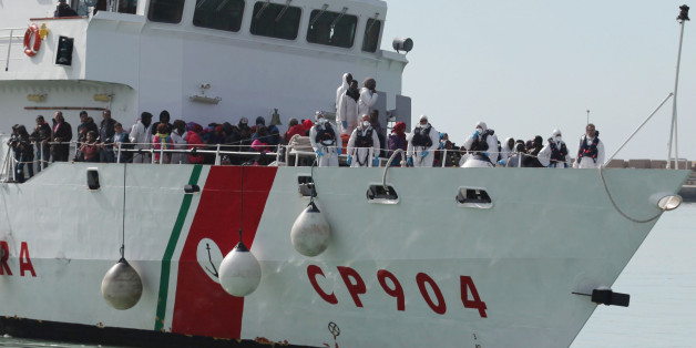 FILE - In this Wednesday, March 4, 2015, file photo, rescued migrants wait to disembark from an Italian Coast Guard vessel in Porto Empedocle, Sicily, southern Italy. In a dramatic sea rescue north of Libya, a flotilla of rescue ships saved nearly 1,000 migrants and refugees, while 10 migrants perished in the southern Mediterranean. European Union countries are immersed in a full-fledged migration crisis. With the EU lacking funds and resources, some officials are even floating the idea of a multinational border guard to deal with arrivals of hundreds of thousands from war-torn countries like Syria, poor African nations and non EU neighbors like Kosovo. (AP Photo/Francesco Malavolta, File)