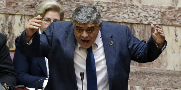 FILE - In this photo taken on Wednesday, June 4, 2014 the leader of the far-right political party Golden Dawn Nikolaos Michaloliakos speaks at the Parliament in Athens. A judicial panel in Athens on Wednesday, Feb. 4, 2015 has ruled that the leader and lawmakers from the extreme right Golden Dawn party will stand trial on criminal charges of participating in a criminal group â an offence that carries a 20-year prison sentence. (AP Photo/Thanassis Stavrakis, File)