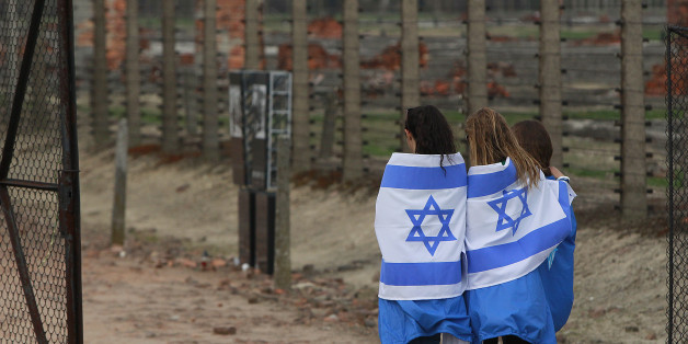 Participants with Israeli flags arrive for the annual silent March of the Living at the Auschwitz-Birkenau Nazi death camp memorial to honor more than 1 million people, mostly Jews, killed at the camp from 1940-45, in Oswiecim, Poland, Thursday, April 16, 2015. (AP Photo/Czarek Sokolowski)