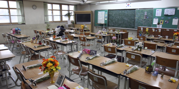 In this April 12, 2015, photo, survivor Yang Jeong-won, a student who was rescued from the sunken Sewol ferry, puts her head on her desk inside a classroom at Danwon High School in Ansan, South Korea, which has become a memorial for her classmates who were killed. "Field Trip" is still written in big letters on a calendar hanging on Yangâs old classroom wall. The letters cover four days in April last year and mark one of the highlights of the year - a trip, by ferry, to a southern resort is