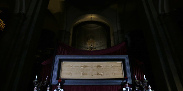The Holy Shroud, the 14 foot-long linen revered by some as the burial cloth of Jesus, is on display at the Cathedral of Turin, Italy, Saturday, April 18, 2015. The long linen with the faded image of a bearded man, that is the object of centuries-old fascination and wonderment, will be on display for the public from April 19 to June 24, 2015. Pope Francis said he is planning to visit the Holy Shroud during a a pilgrimage to Turin next June 21, 2015. (AP Photo/Antonio Calanni)