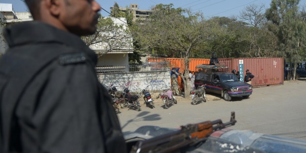 Pakistani policemen stand guard outside the French consulate following protests there against the printing of satirical sketches of the Prophet Muhammad by French magazine Charlie Hebdo in Karachi on January 18, 2015. Thousands demonstrated across the world January 16 and violent clashes erupted in Niger and Pakistan as Muslims vented fury over a new Prophet Mohammed cartoon published by French magazine Charlie Hebdo. AFP PHOTO/Rizwan TABASSUM (Photo credit should read RIZWAN TABASSUM/AFP