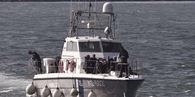 Shipwreck immigrants sit on the ship of Hellenic coast guard as they arrive in the port of Lesvos island on April 17, 2015. Since Greece bolstered controls along its land border with Turkey, along the Evros River, illegal immigrants have turned to the maritime route between Turkey and the Greek islands in the Aegean Sea, notably Lesvos, Samos, Kos and Chios. 2015 started with a major increase in the number of Aegean crossings : 10,445 against 2,863 in the same period of 2014, according to the Gr