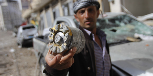 A man holds a projectile fragment after a Saudi-led airstrike against Iran-allied Shiite rebels, known as Houthis, hit a site of a weapons cache in Yemen's capital, Monday, April 20, 2015. Airstrikes on weapons caches in Yemen's rebel-held capital on Monday caused massive explosions that shattered windows, sent residents scrambling for shelter and killed a local TV presenter. (AP Photo/Hani Mohammed)