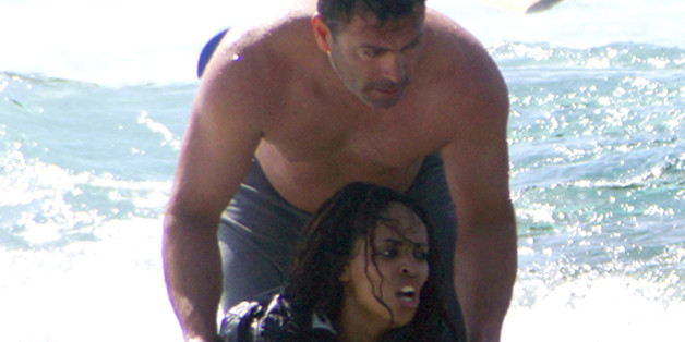 FILE - This is a Monday, April 20, 2015 file photo of a man as he rescues Wegasi Nebiat an Eritrean migrant from the Aegean sea, in the Greek island of Rhodes. Nebiat was pictured in dramatic rescue footage after sailboat carrying Syrian and Eritrean migrants sank on Monday, leaving three people dead. She was released from hospital earlier Thursday April 23, 2015 and was sailing to Greece's main port of Piraeus, near Athens. (Argiris Mantikos/Eurokinissi via AP, File) GREECE OUT