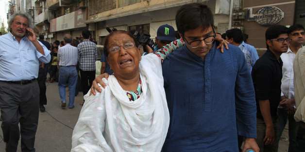 A woman mourns after attending the funeral prayers of prominent women's rights activist Sabeen Mehmud, who was killed by unknown gunmen in Karachi, Pakistan on Saturday, April 25, 2015. Gunmen on a motorcycle killed Mehmud in Pakistan just hours after she held a forum on the country's restive Baluchistan region, home to a long-running insurgency, police said Saturday. (AP Photo/Fareed Khan)