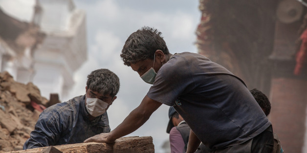 KATHMANDU, NEPAL - APRIL 27: Volunteers clear debris of a collapsed temple at Basantapur Durbar Square on April 27, 2015 in Kathmandu, Nepal. A major 7.8 earthquake hit Kathmandu mid-day on Saturday, and was followed by multiple aftershocks that triggered avalanches on Mt. Everest that buried mountain climbers in their base camps. Many houses, buildings and temples in the capital were destroyed during the earthquake, leaving over 3000 dead and many more trapped under the debris as emergency rescue workers attempt to clear debris and find survivors. (Photo by Omar Havana/Getty Images)
