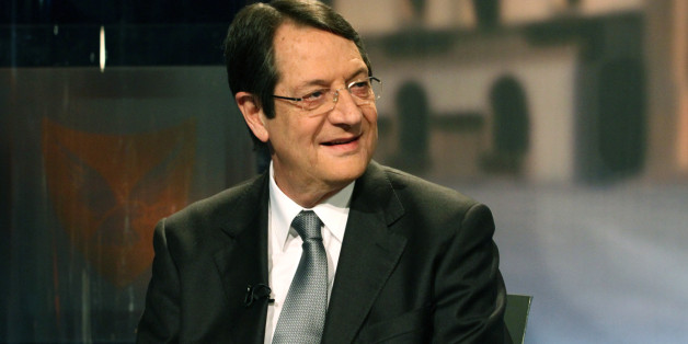 Nikos Anastasiadis sits along side Stavros Malas and George Lillikas (both unseen), the three major candidates in the Cypriot presidential election, attend the last televised political debate in Nicosia, on February 11,2013. The presidential elections will be held on February 17. AFP PHOTO/YIANNIS KOURTOGLOU (Photo credit should read Yiannis Kourtoglou/AFP/Getty Images)