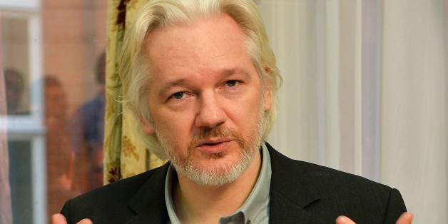 WikiLeaks founder Julian Assange gestures during a press conference inside the Ecuadorian Embassy in London on August 18, 2014 where Assange has been holed up for two years. WikiLeaks founder Julian Assange said Monday he would 'soon' leave Ecuador's embassy in London but his organisation played down the comment, saying he would not depart until there was an agreement with Britain's government. Assange took refuge in June 2012 in the Ecadorian Embassy to avoid extradition to Sweden, where he faces allegations of rape and sexual molestation, which he strongly denies. AFP PHOTO / POOL / JOHN STILLWELL (Photo credit should read JOHN STILLWELL/AFP/Getty Images)