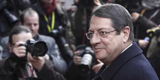 Cypriot President Nikos Anastasiadis walks in during an EU summit at the European Council building in Brussels, Thursday, Dec. 19, 2013. The economic crisis is on the EU summit's agenda, as well as issues ranging from defense and banking to relations with Ukraine and the crisis in Central African Republic. (AP Photo/Francois Walschaerts)