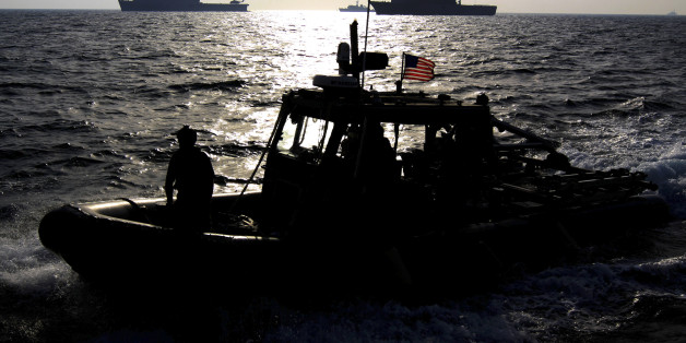 In this picture taken Friday, Sept. 21, 2012, a U.S. Navy speedboat passes in front of multinational military ships as it approaches the British Royal Navy's HMS Atherstone, unseen, in the Persian Gulf. More than 30 nations are participating in an exercise responding to simulated sea-mine attacks in international waters _ a demonstration of international resolve to ensure maritime security in the strategic but volatile region. (AP Photo/Hasan Jamali)