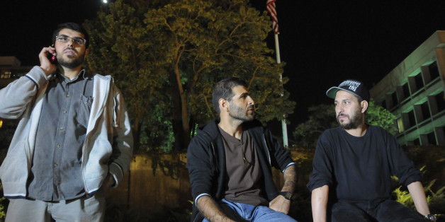 Three freed Guantanamo Bay detainees, who were resettled in Uruguay, protest outside the U.S. embassy in Montevideo, Uruguay, Friday, April 24, 2015. From left are Omar Abdelahdi Faraj and Ali Husain Shaaban, both of Syria, and Adel bin Muhammad El Ouerghi, of Tunisia. The men are protesting after they were asked to leave a hotel where some stayed periodically, and demand Washington help them financially. They say the house where they were initially resettled didn't have enough space for all of