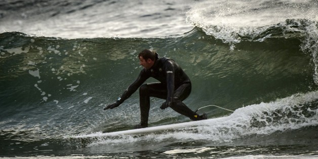 Norwegian Tommy Olsen surfs in Unstad, in the Lofoten Islands within the Arctic Circle, on April 18, 2015. Surfing in the Lofoten Islands has started early in the 60's, and is possible all year long in the Atlantic waters close to 5°C at winter time and and 11°C at summer time. AFP PHOTO / OLIVIER MORIN (Photo credit should read OLIVIER MORIN/AFP/Getty Images)