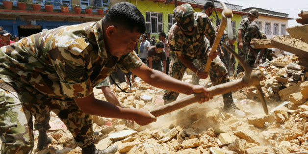 Nepalese soldiers dig for a rumored missing person in the rubble of a collapsed house in the Manakamana village known for its spiritual Hindu temple, near the epicenter of last week's massive earthquake, in the Gorkha District of Nepal, Friday, May 1, 2015. (AP Photo/Wally Santana)