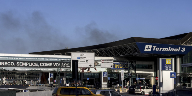 Smoke billows from Rome's Fiumicino airport main international terminal after a fire broke out overnight, Thursday, May 7, 2015. Italy's flagship Alitalia airline said in a statement that all departures have been canceled up to 2 p.m. (1200 GMT) and that only intercontinental flights will be allowed to land during that period. The fire, which broke out after midnight, involved about 400 square meters (more than 4,000 square feet) of retail space. No cause was immediately identified. (Massimo Pe