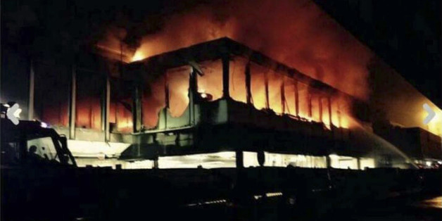 Flames rise from Rome's Fiumicino airport main international terminal after a fire broke out overnight, Thursday, May 7, 2015. Italy's flagship Alitalia airline said in a statement that all departures have been canceled up to 2 p.m. (1200 GMT) and that only intercontinental flights will be allowed to land during that period. The fire, which broke out after midnight, involved about 400 square meters (more than 4,000 square feet) of retail space. No cause was immediately identified. (Domenico Pal