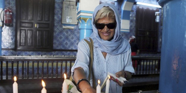 Tunisian Jew Chantal Dabi lights a candle at the Ghriba synagogue in Djerba, south Tunisia, Wednesday, May 6, 2015. Pilgrims arrived for the pilgrimage at Tunisia's Ghriba synagogue, the oldest in Africa. On April 11, 2002 a deadly attack on the synagogue killed 21 people, including 14 German tourists. (AP Photo/Mohsen May)