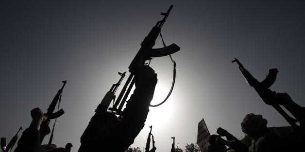 Shiite rebels known as Houthis hold up their weapons to denounce the Saudi-led airstrikes as they chant slogans during a protest in Sanaa, Yemen, Monday, April 27, 2015. Saudi-led airstrikes on Monday targeted Shiite rebels across Yemen, killing several people in the southern port city of Aden and striking a weapons depot in the rebel-held capital, officials and witnesses said. (AP Photo/Hani Mohammed)
