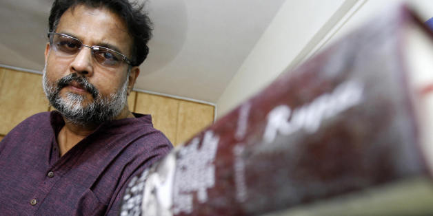 Mumbai, INDIA: TO GO WITH India-history-literature-people,sched-FEATURE by Parul Gupta This picture taken 08 March, 2007 shows Indian author and great-grandson of the father of the Indian nation Mohandas Karamchand Gandhi or 'Bapu' -- Tushar Gandhi, with some books in Mumbai. In his most recent book, Tushar Gandhi seeks to demolish some of the theories revolving around Gandhi's assasination in 1948 by Nathuram Godse, a right-wing Hindu extremist said to be against the percieved pampering of Muslims by the leader. In the process, the leader's great grandson rakes up a host of contentious claims -- chiefly that some Brahmins were against Gandhi's idea of a casteless society which threatened their sway over India's ancient hierarchical system. AFP PHOTO/Indranil MUKHERJEE (Photo credit should read INDRANIL MUKHERJEE/AFP/Getty Images)