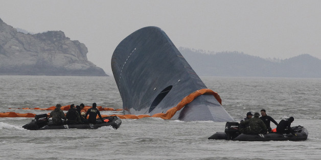 FILE - In this April 17, 2014 file photo, South Korean Coast Guard officers search for missing passengers aboard sunken ferry Sewol in the waters off the southern coast near Jindo, South Korea. One month after the ferry sinking that left more than 300 people dead or missing, there is a national debate - and spasms of shame and fury - over issues neglected as the country made its breakneck way from poverty, war and dictatorship to one of Asiaâs top economic, diplomatic and cultural powers. T