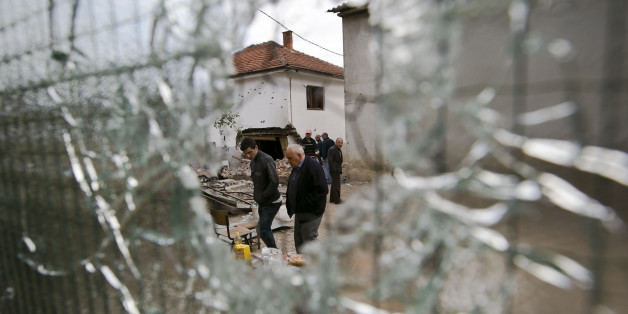 Residents visit the neighborhood where a battle took place over the weekend involving the police and an armed group, in northern Macedonian town of Kumanovo, early Monday, May 11, 2015. (AP Photo/Visar Kryeziu)