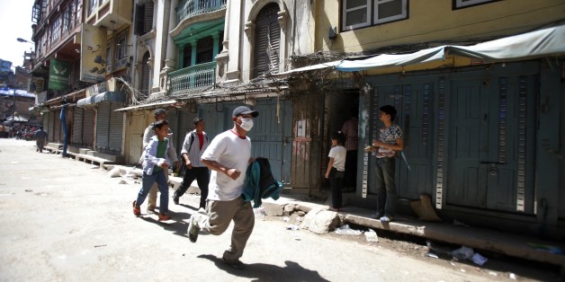 A Nepalese man runs to safety after a second earthquake hit Nepal in Kathmandu, Nepal, Tuesday, May 12, 2015.
