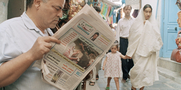 An unidentified Tunisian reads news of the ongoing meetings of the Fatah faction of the Palestinian Liberation Organization in a local newspaper in the old part of Tunis on Sept. 3, 1993. PLO head Yasser Arafat is trying to win the approval of key Palestinian leaders for a landmark accord with Israel. (AP Photo/Francois Mori)