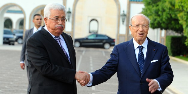 Tunisian President Beji Caid Essebsi, right, shakes hands with his Palestinian counterpart, Mahmoud Abbas, at the presidential palace in Carthage outside Tunis. Tuesday, May 12, 2015. (AP Photo/Hassene Dridi)