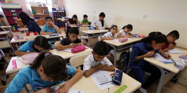 TO GO WITH AFP STORY BY EMILIENNE MALFATTO
Pupils sit ina classroom at the international French School MLF 'Danielle Mitterrand' on September 28, 2014 in Arbil, the capital of the autonomous Kurdish region of northern Iraq. The walls have been fortified and armed guards monitor the entrance of the French school but expatriates want to continue to live a normal life despite the threat of Islamic State (IS) group against France. AFP PHOTO / SAFIN HAMED (Photo credit should read SAFIN HAMED/AFP/Getty Images)
