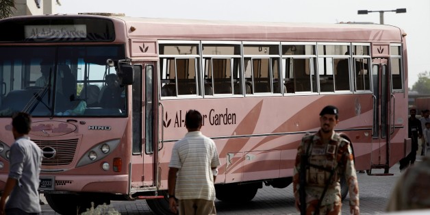 A Pakistani paramilitary trioop stands guard near a bus targeted by attackers in Karachi, Pakistan, Wednesday, May 13, 2015. Gunmen killed dozens of people on Wednesday aboard a bus in southern Pakistan bound for a Shiite community center, in the latest attack targeting the religious minority, police said. (AP Photo/Fareed Khan)