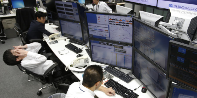 Money traders work at a computer terminal at a foreign exchange brokerage in Tokyo, Friday, Dec. 5, 2014. The dollar gained to 119.89 yen from 119.76 yen. The euro fell to $1.2384 from $1.2386. (AP Photo/Shizuo Kambayashi)