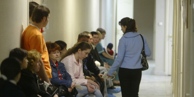 People sit in a hallway at the Saratov regional AIDS center, waiting for blood tests and other medical work in Saratov, 700 kilometers (450 miles) southeast of Moscow, Thursday, May 11, 2006. The country faces a widening epidemic as HIV/AIDS spreads beyond drug users, gay men and prostitutes, into the larger population. (AP Photo/Mikhail Metzel)