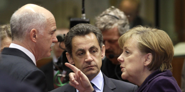 German Chancellor Angela Merkel, right, speaks with Greek Prime Minister George Papandreou, left, and French President Nicolas Sarkozy during a round table meeting at an EU summit in Brussels, Friday, Feb. 4, 2011. EU leaders meet for a one-day summit on Friday, with energy, the eurozone debt crisis and unrest in Egypt set to dominate the agenda. (AP Photo/Yves Logghe)