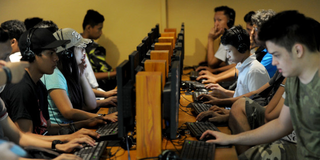 Filipino youths sit in an Internet cafe in Manila on February 18, 2014. The Philippine Supreme Court ruled on February 18 that a controversial cybercrime law penalising online libel is constitutional, amid claims it is intended to curb Internet freedom in one of Asia's most freewheeling democracies. AFP PHOTO / Jay DIRECTO (Photo credit should read JAY DIRECTO/AFP/Getty Images)