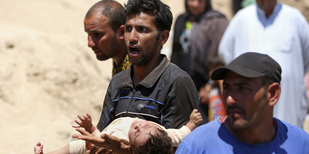 Displaced Iraqis from Ramadi cross the Bzebiz bridge after spending the night walking towards Baghdad, as they flee their hometown, 65 km west of Baghdad, Iraq, Saturday, May 16, 2015. Islamic State militants seized the center of Ramadi in western Iraq and raised their black flag over the government compound, local officials said. (AP Photo/ Hadi Mizban)