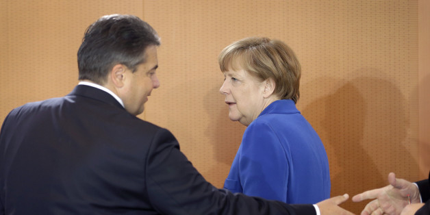German Chancellor Angela Merkel, right, and Vice Chancellor and Economy Minister Sigmar Gabriel, left, arrive for the weekly cabinet meeting at the chancellery in Berlin, Germany, Wednesday, May 6, 2015. (AP Photo/Michael Sohn)