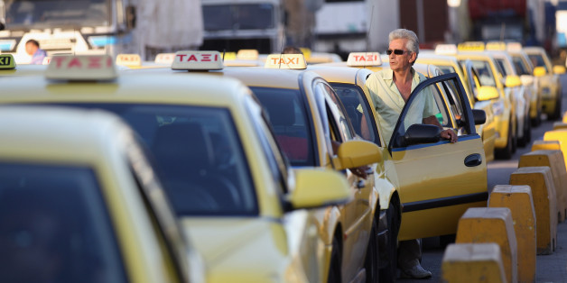 ATHENS, GREECE - JUNE 14: Taxi drivers wait for fares in a rank in Piraeus, the Port of Athens, on June 14, 2012 in Athens, Greece. The Greek electorate are due to go to the polls in a re-run of the general election on June 17, 2012 after no combination of political parties were able to form a coalition government. Recent opinion polls have placed the anti-bailout party 'Syriza' equal in popularity with the pro-bailout 'New Democracy' ahead of Sunday's general election which could determine whet
