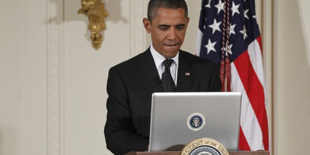 President Barack Obama uses a laptop computer to send a tweet during a "Twitter Town Hall" in the East Room of the White House in Washington, Wednesday, July 6, 2011. (AP Photo/Charles Dharapak)