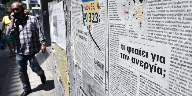 A poster reads "Why unemployment (is high)?'' outside an office of the Labor Force Employment Organization (OAED) in central Athens, Thursday, June 6, 2013. Unemployment in recession-mired Greece continued its record-setting rise in March, reaching 26.8 percent of the workforce compared to a revised 26.7 percent a month earlier. (AP Photo/Petros Giannakouris)