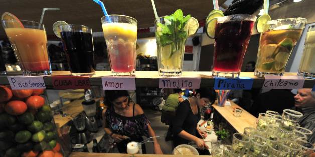 Fair workers at the Peru stand make cocktails (Cuba Libre, Mojito, Pirana) for visitors at the International Green Week (Gruene Woche) Food and Agriculture Fair in Berlin January 23, 2011. Some 1.200 exhibitors are taking part in this year's edition with countries such as Afghanistan and Rwanda making their fair debut. The fair takes place from January 21st to January 30th. AFP PHOTO / JOHN MACDOUGALL (Photo credit should read JOHN MACDOUGALL/AFP/Getty Images)