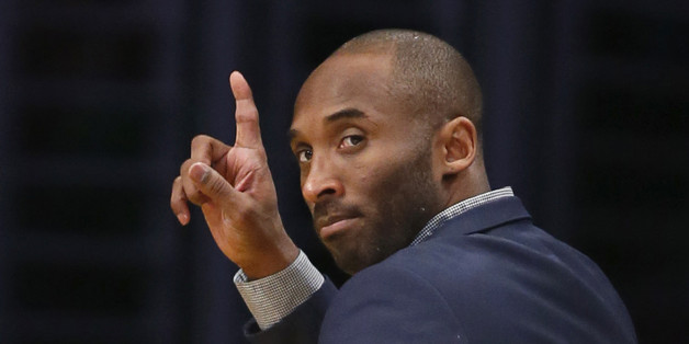 Los Angeles Lakers' Kobe Bryant waves to Detroit Pistons' Jodie Meeks as he leaves the court after an NBA basketball game, Tuesday, March 10, 2015, in Los Angeles. The Lakers won 93-85. (AP Photo/Danny Moloshok)
