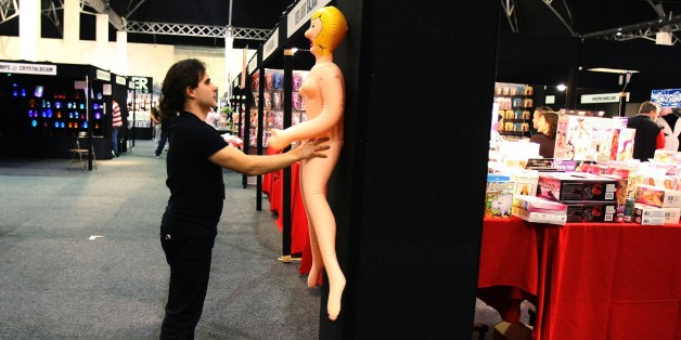 SYDNEY, AUSTRALIA - JULY 26: A stall employee positions a blow-up sex doll for a display during the opening day of Sexpo Sydney July 26, 2007 in Sydney, Australia. Sexpo is marketed as Australia's health, sexuality and adult-lifestyle exhibition, with trade stalls, live shows and rides. Approximately 55,000 people attended last years event. (Photo by Ian Waldie/Getty Images)