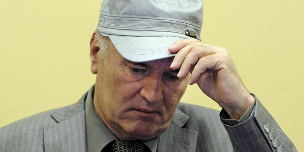 FILE - In this June 3, 2011 file photo, former Bosnian Serb Gen. Ratko Mladic removes his hat in the court room during his initial appearance at the U.N.'s Yugoslav war crimes tribunal in The Hague, Netherlands. Former Bosnian Serb military chief Ratko Mladic was hospitalized Thursday July 12, 2012 after complaining of feeling unwell at his genocide trial. Mladic was checked by a nurse at the tribunal after feeling ill and then sent to hospital "as a precautionary measure," Yugoslav war crimes t