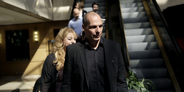 Greek Finance Minister Yanis Varoufakis, right, arrives at an economic conference in Athens, on Tuesday, May 14, 2015. Varoufakis said Thursday that he will reject any deal with bailout creditors unless it helps Greece escape from its financial crisis. (AP Photo/Petros Giannakouris)