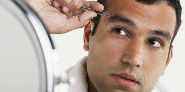 Hispanic man tweezing eyebrows