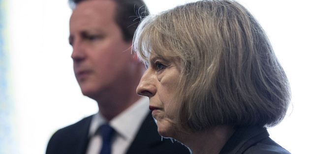 Prime Minster David Cameron and Home Secretary Theresa May speak to Home Office Immigration Enforcement officers at a property where six immigrants were arrested in Slough, Berkshire.